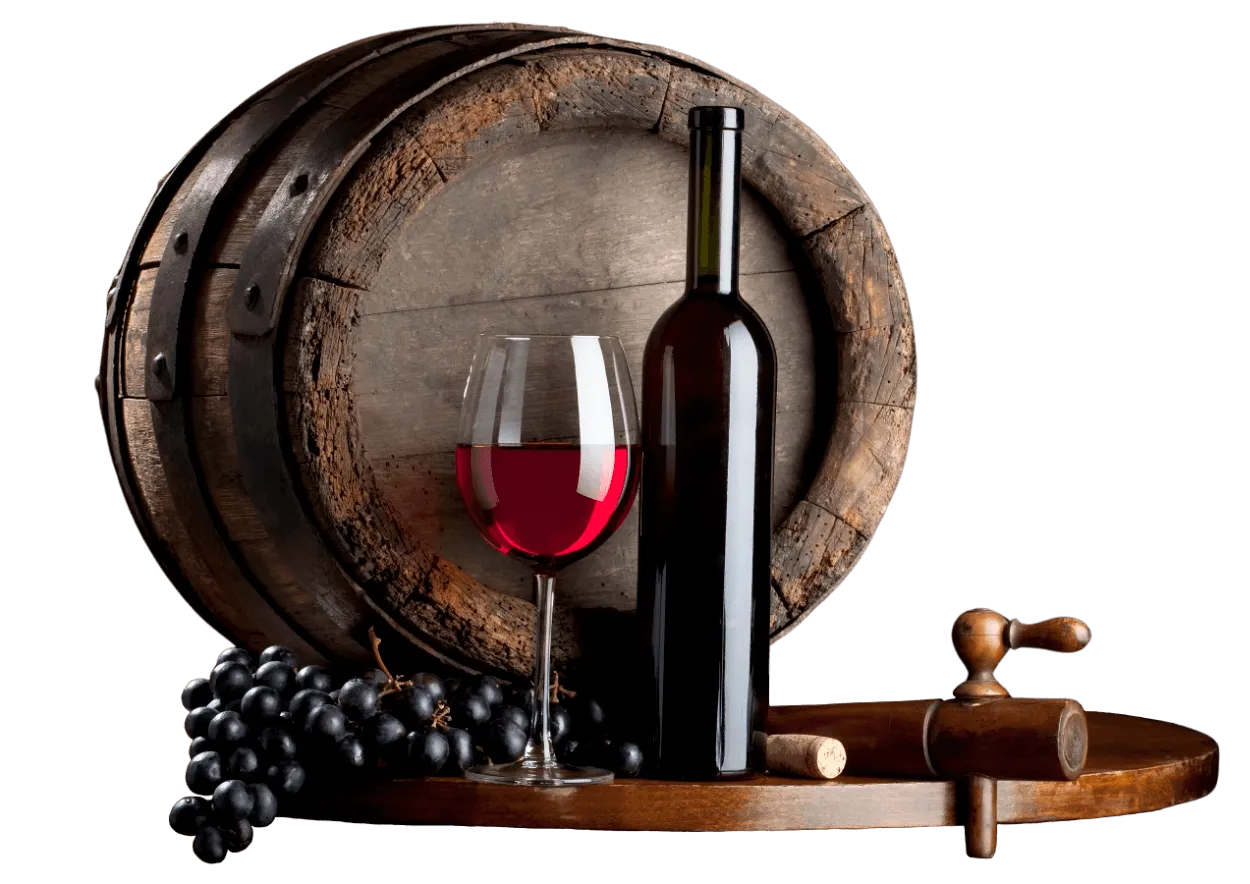 Wine glass and bottle in front of a barrel, with grapes and a wooden tap