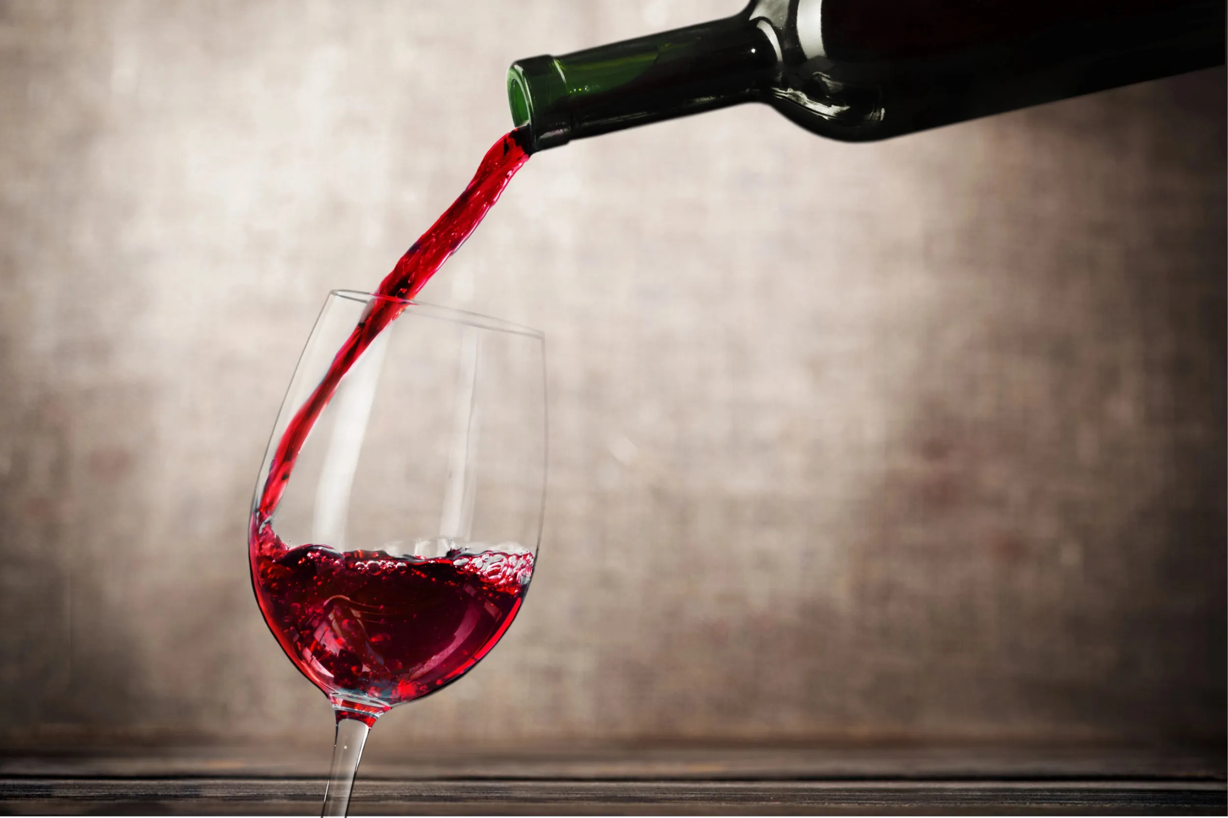 Red wine pouring from a bottle into a glass